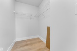 White wire shelving, wood-finish flooring, and white baseboards - 