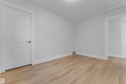 Light wood-finish flooring with crisp white walls and trim - 