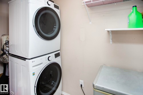 Stackable washer and dryer appliances, wall-mounted shelving - #201 1070 Mcconachie Bv Nw, Edmonton, AB 