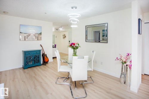 Wood-finish flooring throughout, white walls, and recessed lighting - #201 1070 Mcconachie Bv Nw, Edmonton, AB 