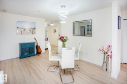 Wood-finish flooring throughout, white walls, and recessed lighting - 