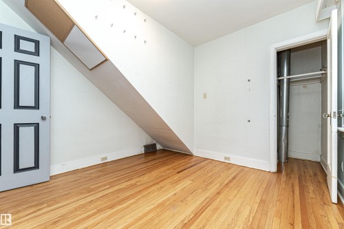 Wood-finish flooring with white baseboards - 10930 80 Avenue Nw, Edmonton, AB 