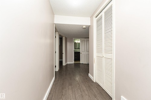 Wood-finish flooring throughout, paired with light-toned walls - 10930 80 Avenue Nw, Edmonton, AB 