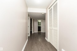 Wood-finish flooring throughout, paired with light-toned walls - 