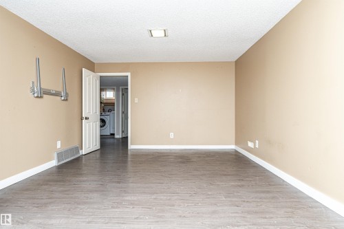 Wood-finish flooring with neutral wall paint and white trim - 10930 80 Avenue Nw, Edmonton, AB 