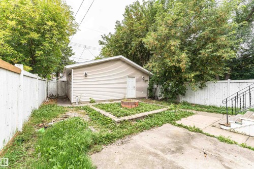 Detached auxiliary structure with siding, exterior lighting, and a white entry door - 10930 80 Avenue Nw, Edmonton, AB 