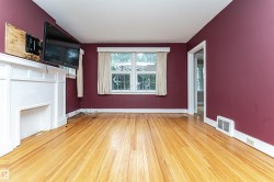 Hardwood flooring, painted interior walls, white trim, and a white mantelpiece - 
