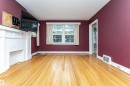 Hardwood flooring, painted interior walls, white trim, and a white mantelpiece - 10930 80 Avenue Nw, Edmonton, AB 