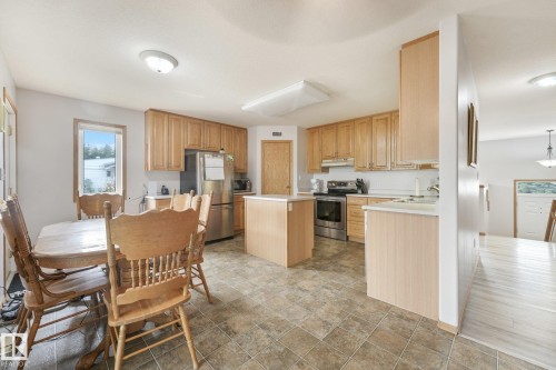 Kitchen featuring light wood cabinetry, stainless steel appliances, and a central island - 54 Buskmose Dr, Rural Wetaskiwin County, AB - Indoor