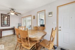 Dining area with neutral wall paint and wood-finish trim - 
