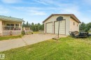 Detached two-car garage with light-colored siding and a brown trim roof - 54 Buskmose Dr, Rural Wetaskiwin County, AB  - Outdoor With Deck Patio Veranda With Exterior 