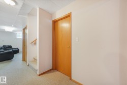 Interior hallway with light-toned walls and wood-finish doors - 