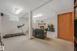 Spacious room with light-colored carpeting, recessed lighting, and perimeter windows - 