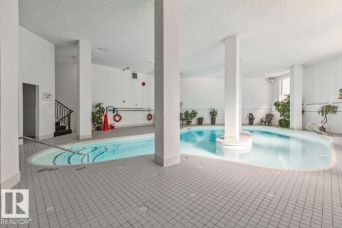 Indoor swimming pool with an irregular shape and tiled surround - #1307 10045 117 St Nw, Edmonton, AB 
