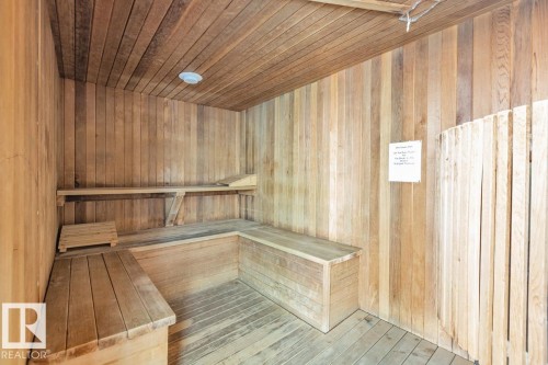 Wood-paneled sauna featuring built-in benches and slatted wood flooring - #1307 10045 117 St Nw, Edmonton, AB 