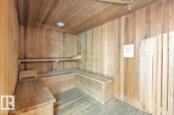 Wood-paneled sauna featuring built-in benches and slatted wood flooring - 