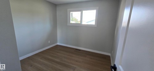 Wood-finish flooring, light gray wall paint, and white trim - 13812 63 Street Nw, Edmonton, AB 