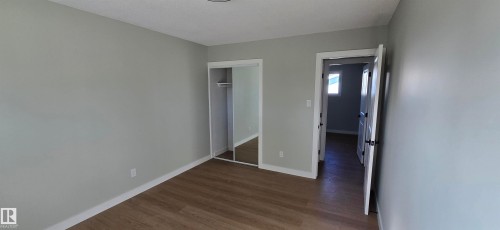 Wood-finish flooring, mirrored closet doors, and recessed lighting - 13812 63 Street Nw, Edmonton, AB 