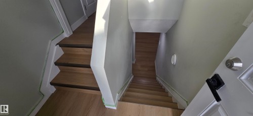 Wood-finish flooring throughout the staircase and hallway - 13812 63 Street Nw, Edmonton, AB 