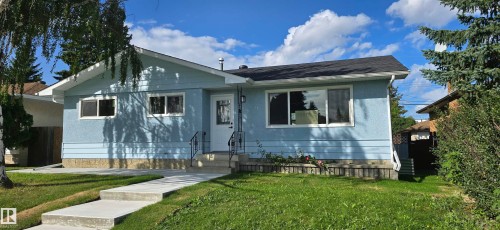 Light blue exterior with white trim, a black asphalt shingle roof, and an inviting front entrance with a handrail - 13812 63 Street Nw, Edmonton, AB 