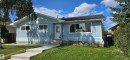 Light blue exterior with white trim, a black asphalt shingle roof, and an inviting front entrance with a handrail - 13812 63 Street Nw, Edmonton, AB 