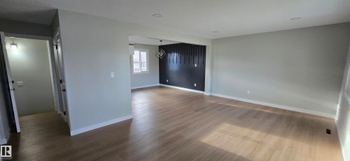 Light wood-finish flooring throughout, complemented by recessed ceiling lighting - 13812 63 Street Nw, Edmonton, AB 