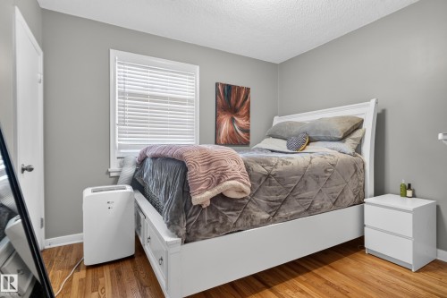 Wood-finish flooring with light gray wall paint - 11406 83 Street Nw, Edmonton, AB 