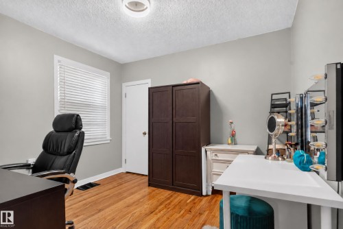 Wood-finish flooring, white trim window with blinds, overhead flush mount lighting, and a white door - 11406 83 Street Nw, Edmonton, AB 