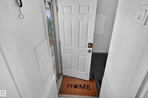 White paneled door with brass hardware - 11406 83 Street Nw, Edmonton, AB 