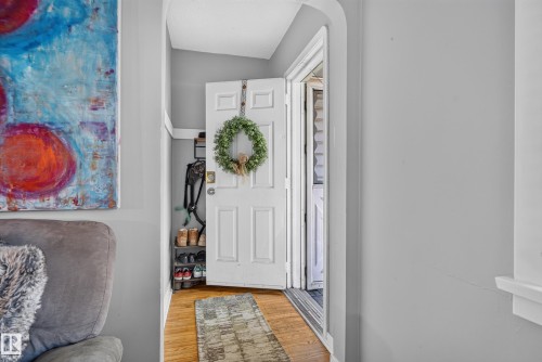 Hardwood flooring, painted interior walls, and a white paneled door - 11406 83 Street Nw, Edmonton, AB 
