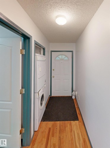 Hardwood flooring, front-loading washer and dryer, and an entry door with an arched transom window - 10941 81 Avenue Nw, Edmonton, AB 