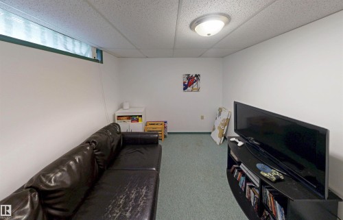 Recessed window opening, neutral wall paint, ceiling-mounted light fixture, and textured ceiling panels - 10941 81 Avenue Nw, Edmonton, AB 