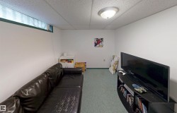 Recessed window opening, neutral wall paint, ceiling-mounted light fixture, and textured ceiling panels - 