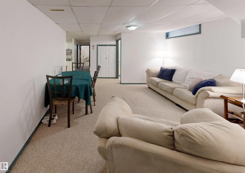 Carpeted flooring, white walls, drop ceiling, recessed lighting, and a horizontal window - 10941 81 Avenue Nw, Edmonton, AB 