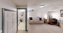 Carpeted floor, built-in shelving, white walls, recessed window, and flush-mount ceiling light - 
