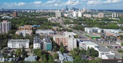 Dense urban landscape featuring multiple high-rise buildings and commercial structures - 
