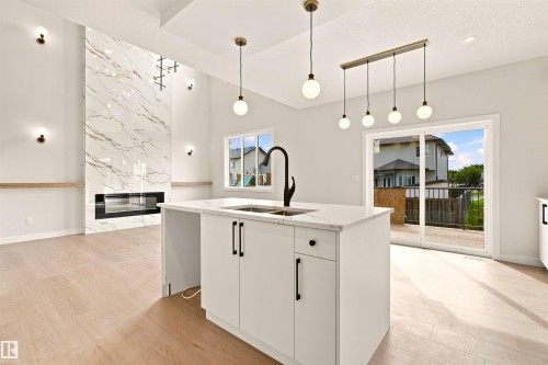 Open-concept layout with wood-finish flooring - 10458 104 Street, Morinville, AB 