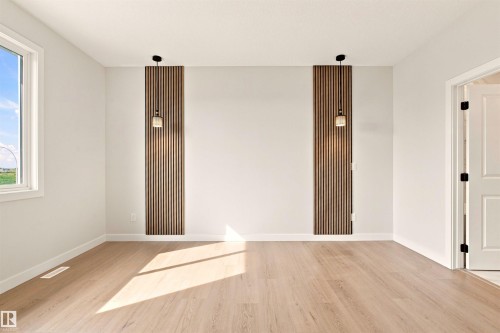Wood-finish flooring, white walls, and a window with white trim - 10458 104 Street, Morinville, AB 