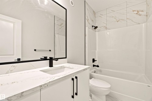 White vanity with an integrated rectangular sink, matte black faucet, and white countertop - 10458 104 Street, Morinville, AB 