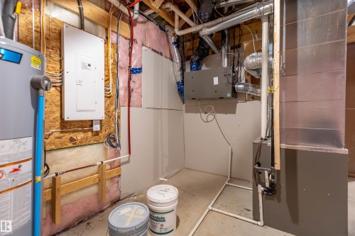 Water heater, electrical service panel, furnace system, ductwork, and exposed ceiling joists - 10458 104 Street, Morinville, AB 