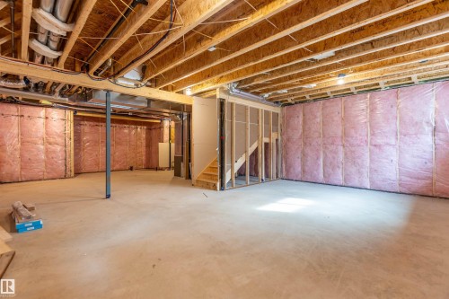 Unfinished basement with exposed ceiling joists, concrete flooring, and insulated perimeter walls - 10458 104 Street, Morinville, AB 