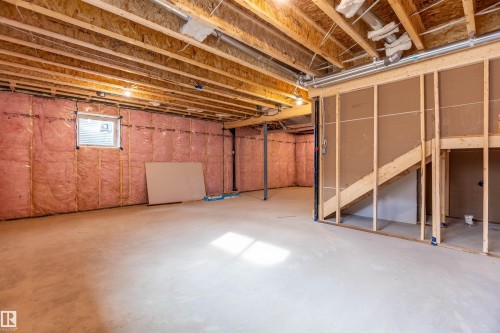Unfinished lower level with exposed ceiling joists, concrete flooring, and insulated walls - 10458 104 Street, Morinville, AB 