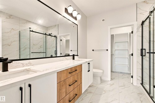 Dual vanity with integrated sinks and wood-finish drawer fronts - 10462 104 Street, Morinville, AB 