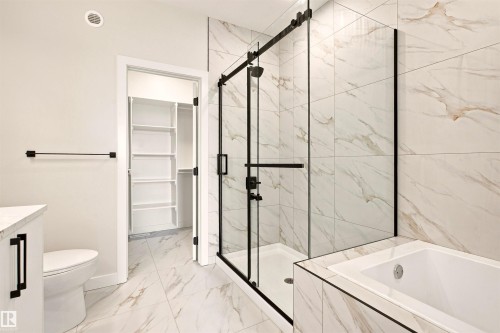 Full bathroom featuring a walk-in shower with a glass enclosure, a built-in soaking tub, and a vanity with a countertop - 10462 104 Street, Morinville, AB 