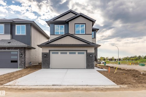 Contemporary exterior with varied siding textures and stone accents - 10462 104 Street, Morinville, AB 