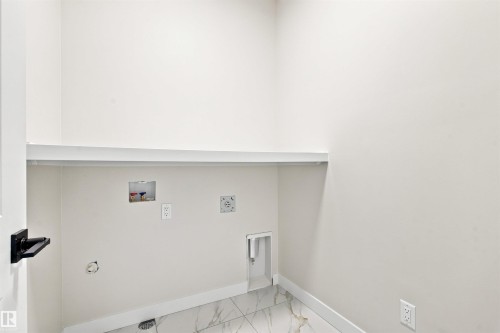 White walls with a single white shelf - 10462 104 Street, Morinville, AB 