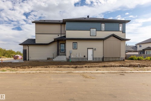 Two-story residence featuring light siding and darker accent siding - 10462 104 Street, Morinville, AB 