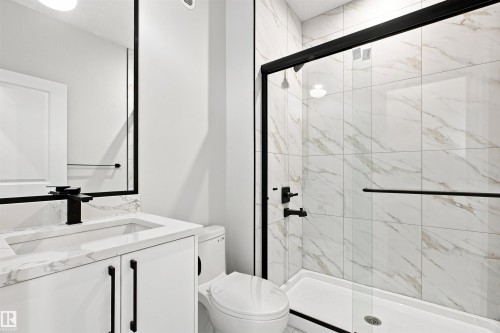 White tile shower with black-framed glass enclosure - 10462 104 Street, Morinville, AB 