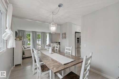 Open-concept living area with a vaulted ceiling and wood-finish flooring - 5 Labelle Crescent, St. Albert, AB 
