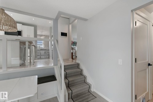 Open-concept living space with light wood-finish flooring - 5 Labelle Crescent, St. Albert, AB 